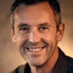 ames Walker, Property Consultant, professional headshot smiling confidently for client testimonial